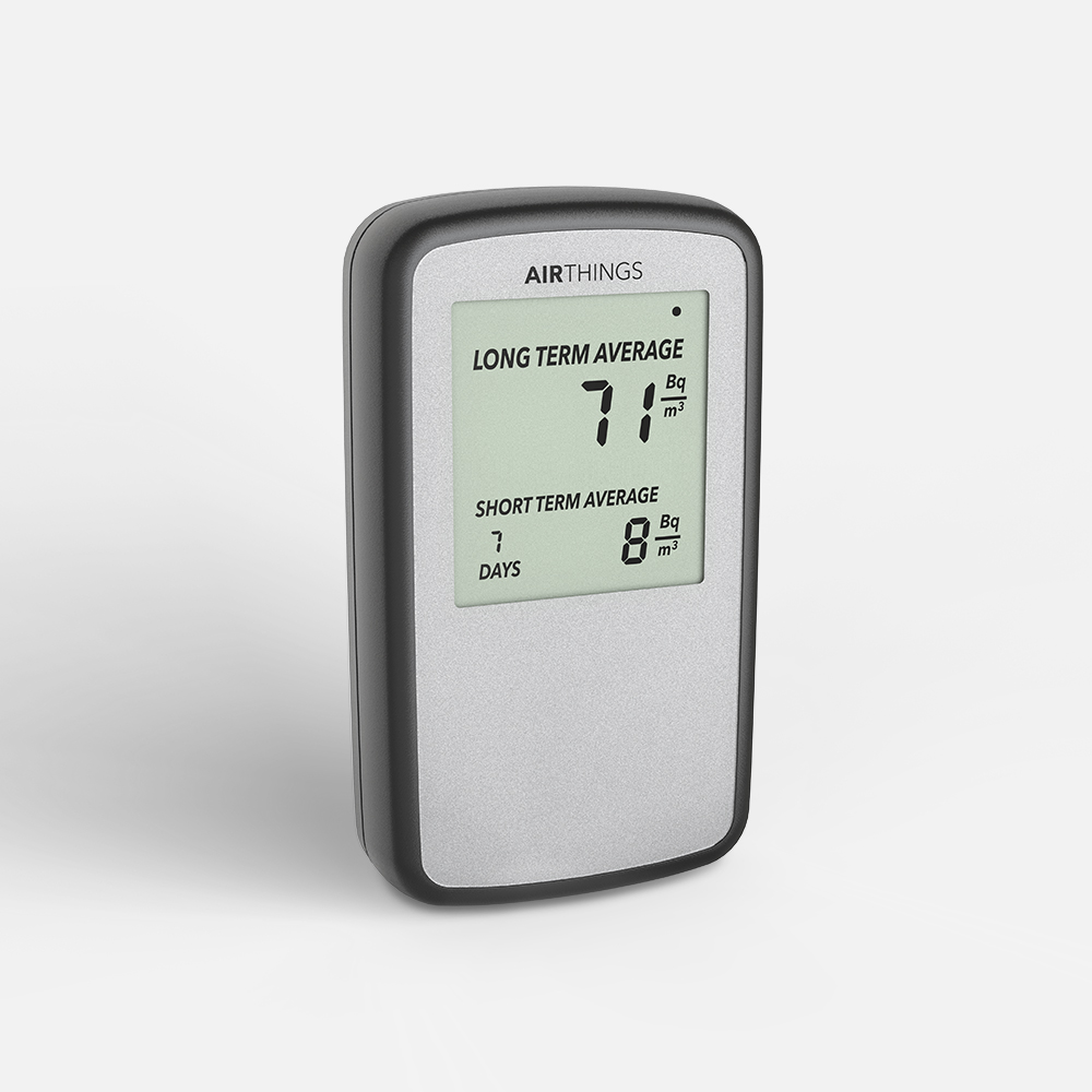 Airthings Corentium Home radon monitor left side view — portable long-term radon detector meeting Health Canada 200 Bq/m³ guideline