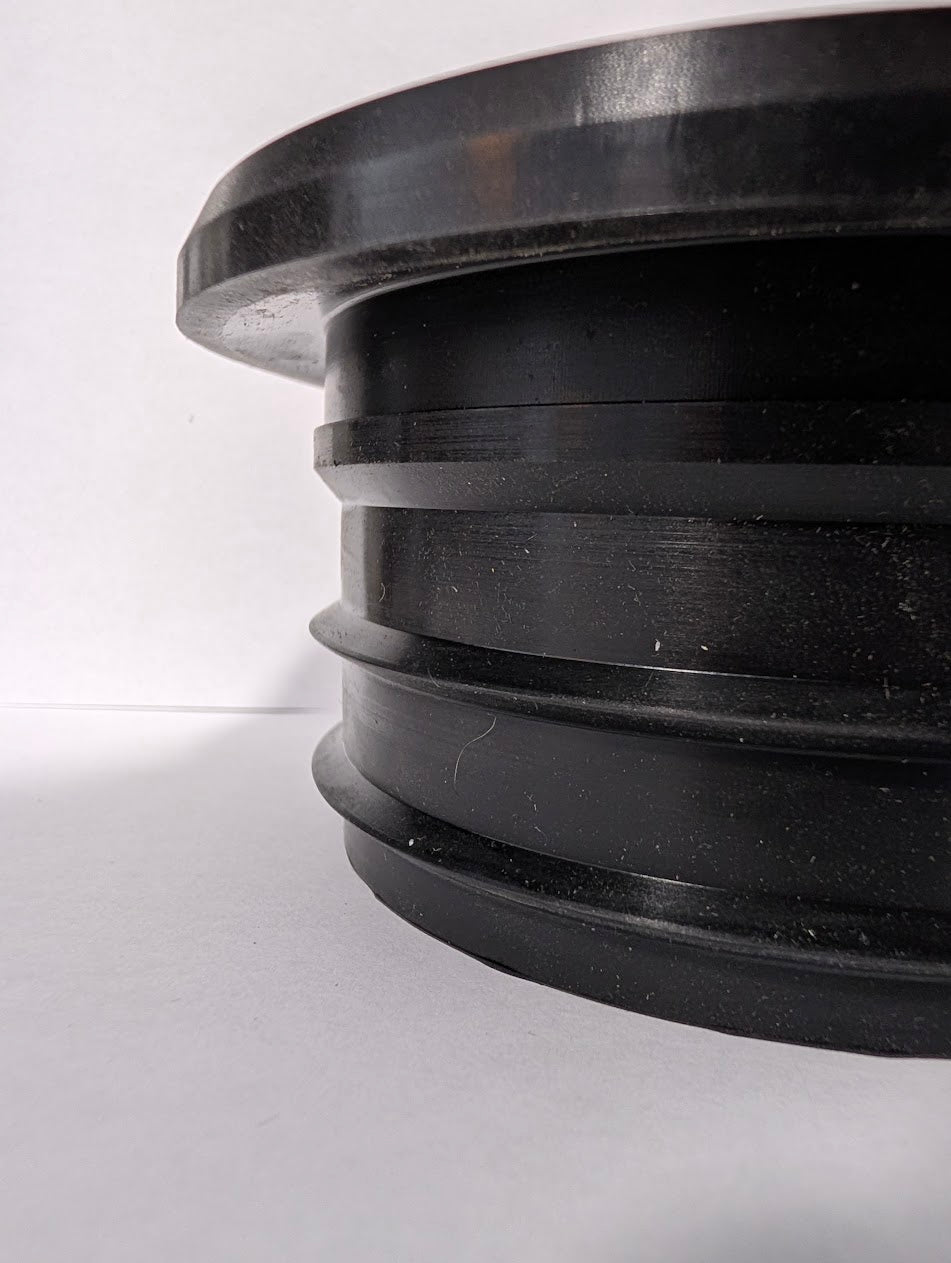 Actual SlabCollar unit — side view showing flange and compression ribs