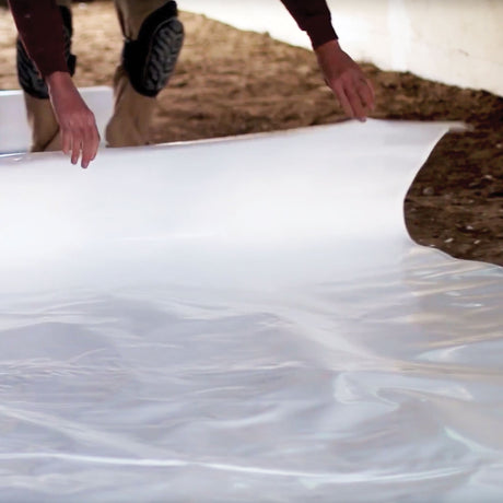 StegoCrawl 15-Mil vapor barrier being installed in Canadian crawlspace — radon mitigation encapsulation