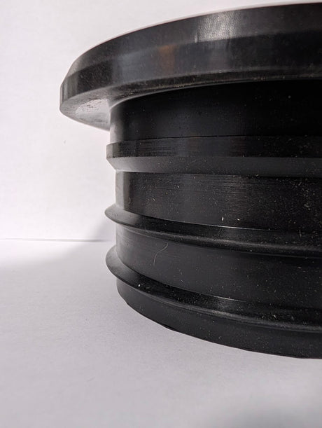 Actual SlabCollar unit — side view showing flange and compression ribs